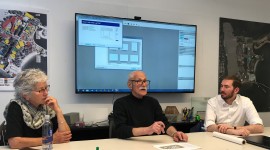 Paul Friedberg and two other people sitting at a desk.