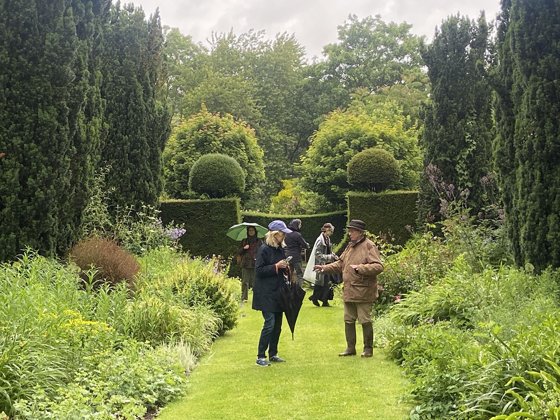 people walking through garden